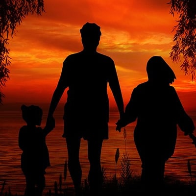 family walking in sunset